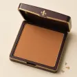 An open square compact of warm tan pressed bronzer.
