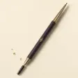 A very slim retractable brow pencil with a spoolie at the other end.