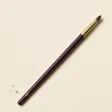 A small, pointed crease brush on a slim handle.