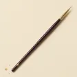 A slim brush with a very fine, pointed liner tip.