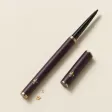 A slim retractable black eyeliner with its cap off.