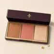 An open palette of bronzer, rose blush and champagne highlighter.