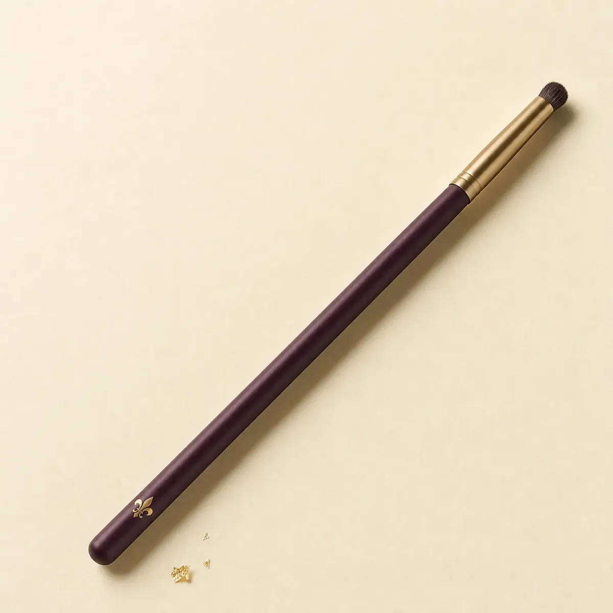 A slim eye brush ending in a tiny, dense, domed smudger tuft.