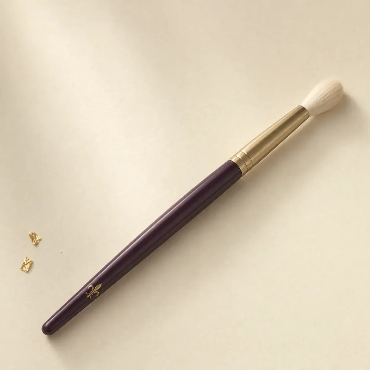 A small, soft, pointed highlighter brush.