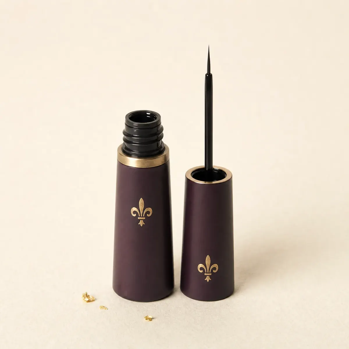 A slim bottle of black liquid eyeliner with its fine brush cap beside it.