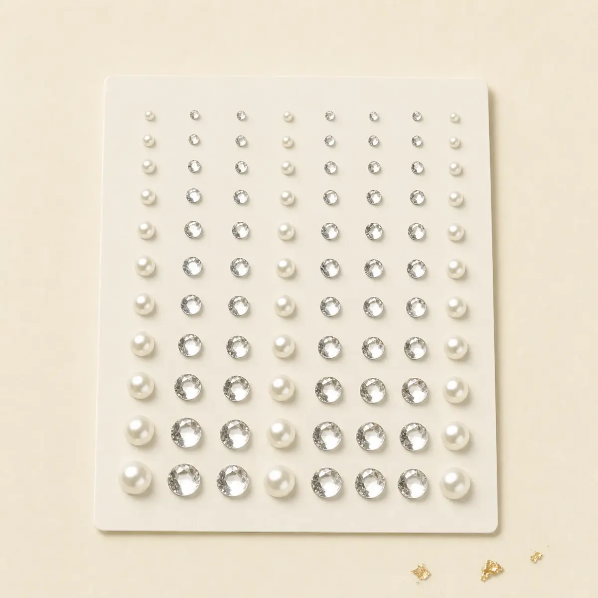 A sheet of small crystal and pearl face gems.