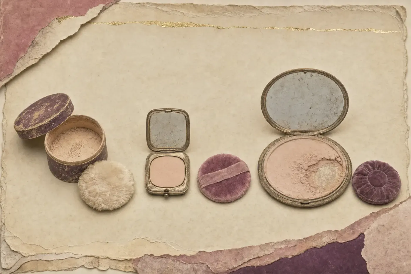 A 1930s powder compact of the wide, flat Flapjack type, a disc about the width of a hand and twice the size of the compacts before it, in gilded metal with a ring-turned lid, its large mirror clouded with age.
