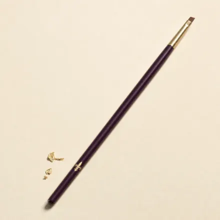 A slim brush with a tiny, thin, angled liner head.