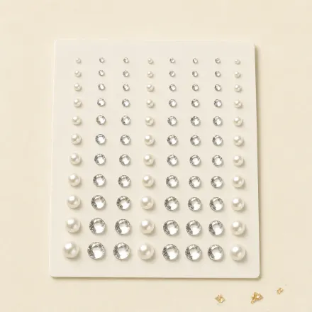 A sheet of small crystal and pearl face gems.