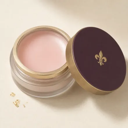 An open shallow pot of translucent balm primer.