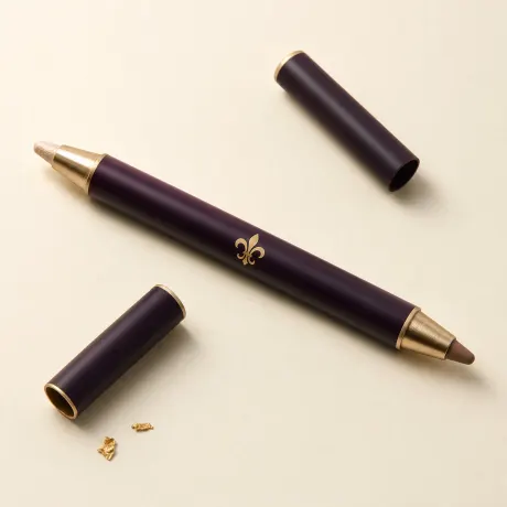 A slim dual-ended pencil with a champagne shimmer end and a taupe end.