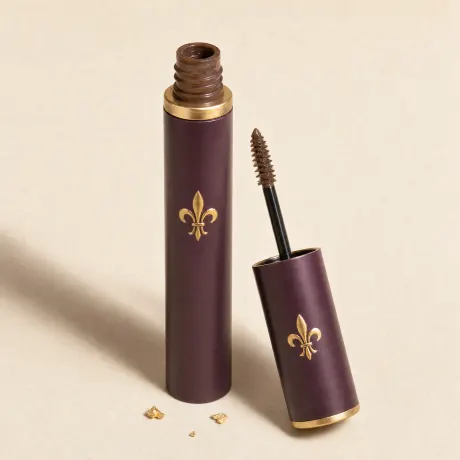 Illustration: A slim tube of brown brow gel with its tiny wand beside it.