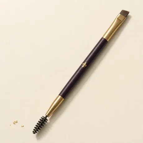 A double-ended brow brush with an angled brush and a spoolie.