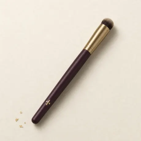 Illustration: A small, dense, domed concealer brush.