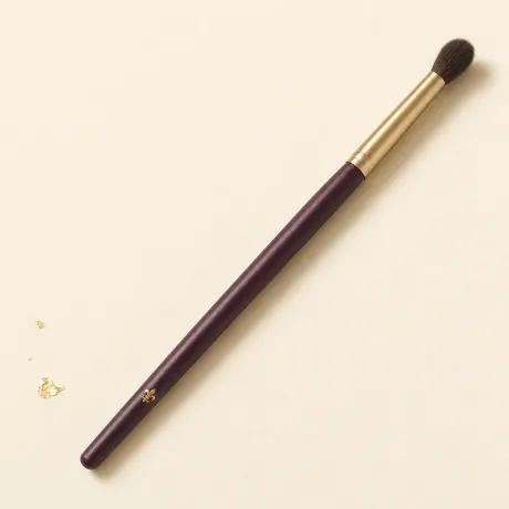 Illustration: A soft, fluffy, tapered eye blending brush on a slim handle.