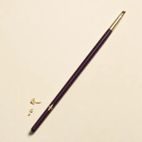 A slim brush with a tiny, thin, angled liner head.