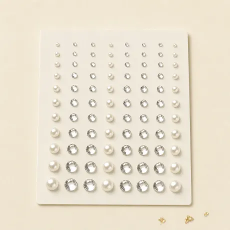 A sheet of small crystal and pearl face gems.