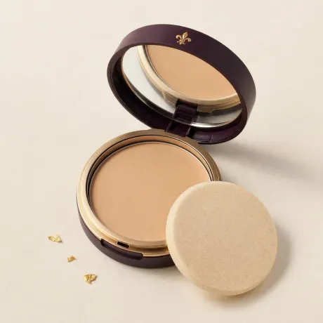 Illustration: An open round compact of pressed beige powder foundation with a flat sponge.