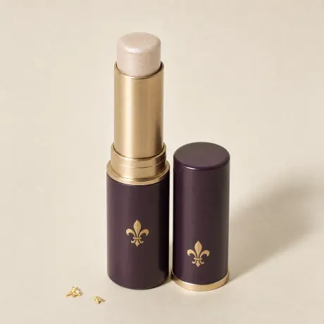 Illustration: An uncapped twist-up stick of pearly cream highlighter.