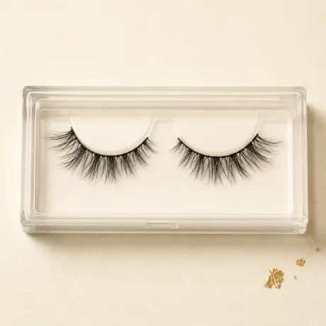 A clear tray holding a pair of wispy black strip lashes.