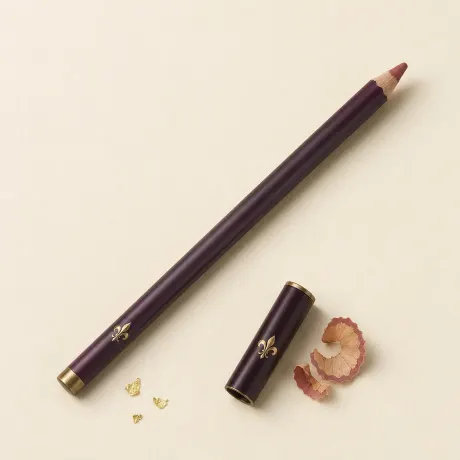 Illustration: A sharpened rosy nude lip pencil with a few shavings.